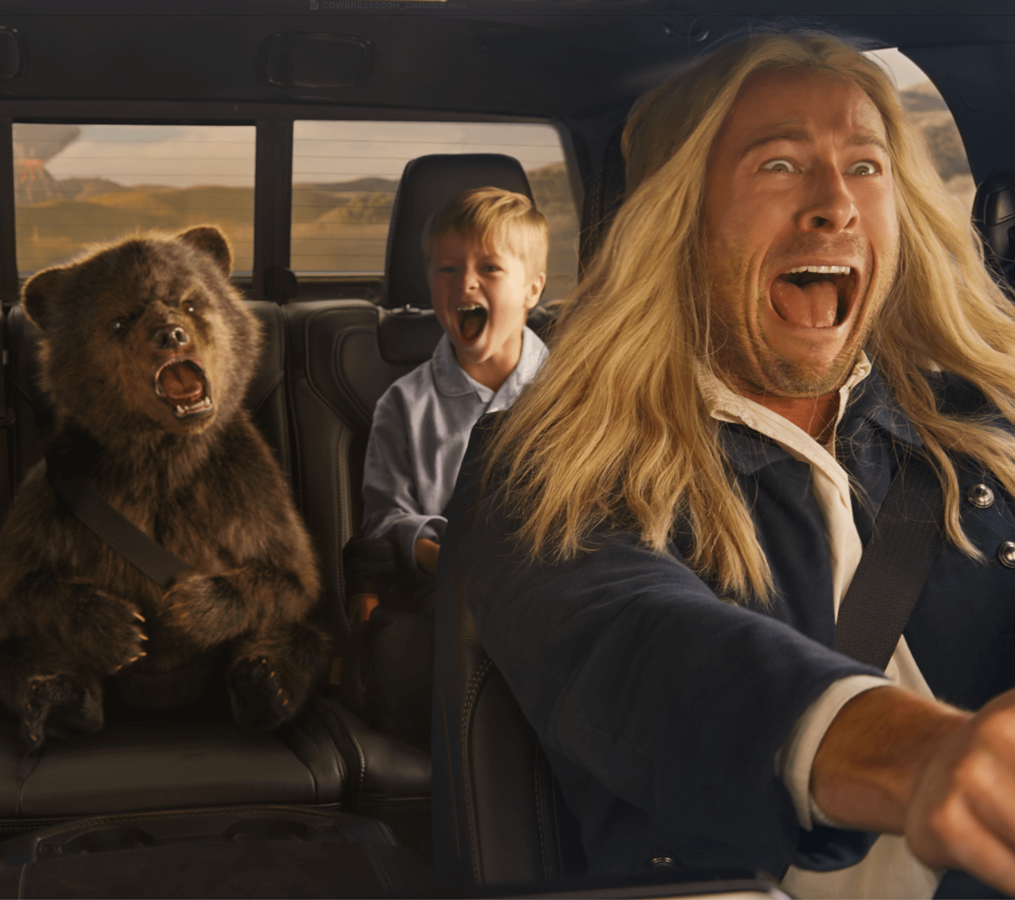 Three people and a bear cub drive away from a volcano